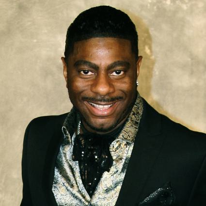 Pierre Jovan full length posed cropped